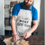 Funny World's Best Grill Guy Apron<br><div class="desc">A trendy bbq apron for men with a funny quote: "World's Best Grill Guy". Makes a great gift—a cool gift idea for dad, uncle, grandpa, son, and all the other men in your life. Show him how special he is this Father's Day. Black vintage typography. Funny Bbq aprons. Grilling gifts...</div>