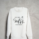 Future Mrs. Bride, Fiancé Engagement Gift Custom Sweatshirt<br><div class="desc">Future Mrs. Bride, Fiancé Engagement Gift Custom name sweatshirt. This shirt makes a nice gift for the glowing bride-to-be! This cosy and stylish sweatshirt features the words "Future Mrs." on the front, allowing her to proudly display her new surname-to-be. What makes this sweatshirt truly special is the customisation option for...</div>