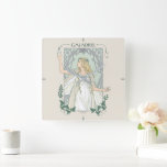 Galadriel Light of Valinor Graphic Square Wall Clock<br><div class="desc">Step into the radiant grace of Middle-Earth™ with this exquisite Lord of the Rings™ design inspired by Galadriel™. Illustrated in an elegant, Art Nouveau–inspired style, she stands poised and luminous, holding a phial of the Light of Valinor with serene strength and quiet authority. Flowing golden hair, delicate Elven adornments, and...</div>