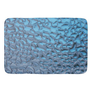 Gentle raindrops on blue glass bath mat