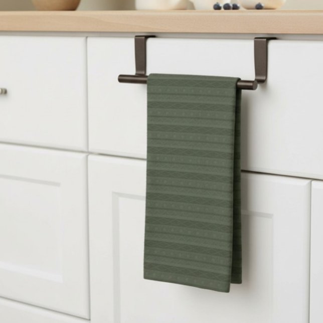 Geometric Aztec Olive Green Striped Tea Towel (geometric, striped, deep green tea towel, neatly hung on a bar on a kitchen counter.)