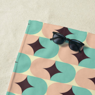 Geometric pattern of teal, beige, and black shapes beach towel