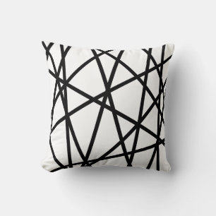 Geometric straight lines crossing black on white cushion