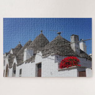 Geranium flowers and trulli houses in Alberobello Jigsaw Puzzle