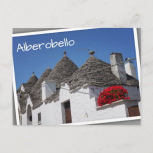 Geranium flowers and trulli houses in Alberobello Postcard