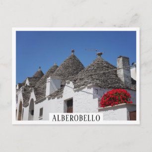 Geranium flowers and trulli houses in Alberobello Postcard