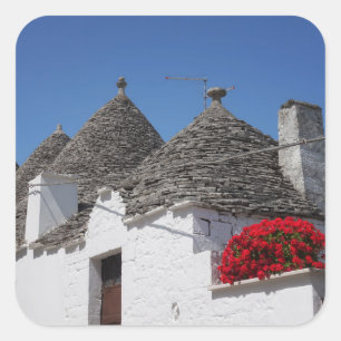 Geranium flowers and trulli houses in Alberobello Square Sticker