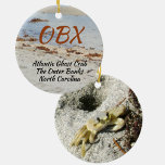Ghost Crab OBX North Carolina Photographic Ceramic Ornament<br><div class="desc">This photographic OBX beach ceramic ornament features an Atlantic Ghost Crab and his burrow in the beach sand. The Atlantic Ghost Crab can be found all along the Atlantic coast. As is, it is a travel souvenir of The Outer Banks North Carolina or the text may be customised with your...</div>