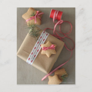 Ginger cookie tied with ribbon in the box postcard