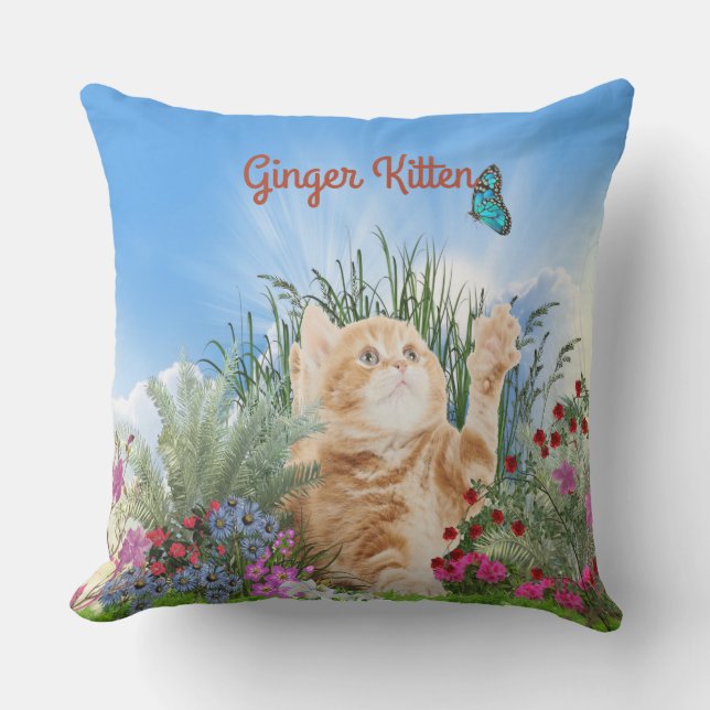 Ginger kitten playing with a butterfly cushion (Front)