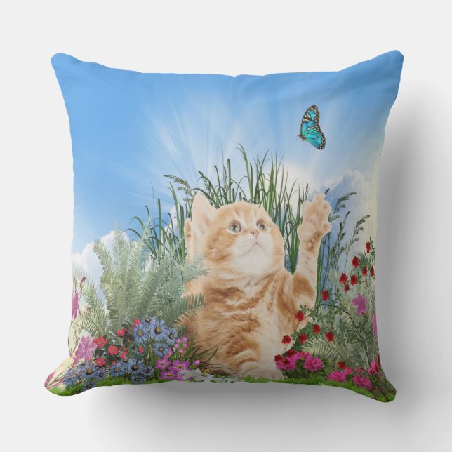 Ginger kitten playing with a butterfly outdoor cushion (Front)