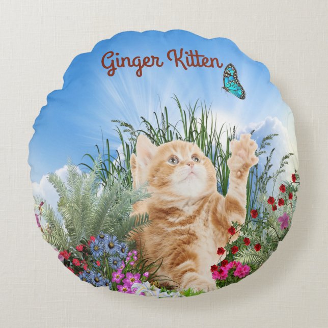 Ginger kitten playing with a butterfly round cushion (Front)