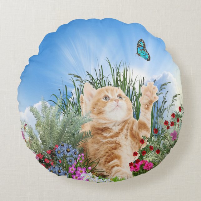 Ginger kitten playing with a butterfly round cushion (Front)