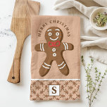 Gingerbread Man Brown Monogram Merry Christmas Tea Towel<br><div class="desc">Celebrate the holiday season with this custom gingerbread man Merry Christmas kitchen towel. Featuring a cute gingerbread man with a red bow tie, a festive "Merry Christmas" greeting, and a personalised monogram on a brown background, this towel adds a fun and festive touch to your kitchen decor. Perfect for gifting...</div>