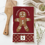 Gingerbread Man Red Monogram Merry Christmas Tea Towel<br><div class="desc">Celebrate the holiday season with this custom gingerbread man Merry Christmas kitchen towel. Featuring a cute gingerbread man with a red bow tie, a festive "Merry Christmas" greeting, and a personalised monogram on a red background, this towel adds a fun and festive touch to your kitchen decor. Perfect for gifting...</div>