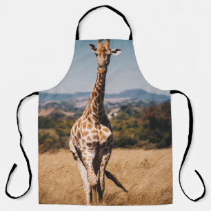 GIRAFFE SURROUNDED BY BROWN GRASS APRON