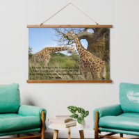 Giraffes out in the field by some trees poster