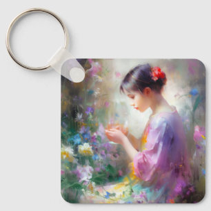Girl admiring a flower in her hands key ring