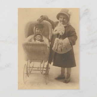 girl and her doll in carriage post card