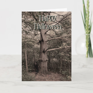 Girl behind tree halloween card