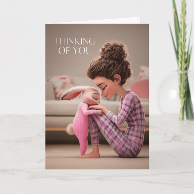 Girl Sitting with Bunny in Pajamas Thinking of You Card (Front)
