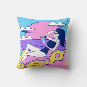 girl sunbathes on the beach with a cocktail in han cushion