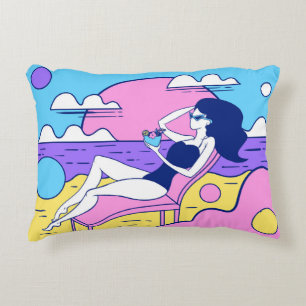 girl sunbathes on the beach with a cocktail in han decorative cushion