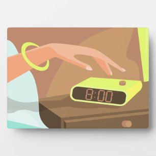 Girls hand pushing on alarm clock snooze button plaque