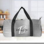 Glam Silver Brushed Metal Black White Monogram  Duffle Bag<br><div class="desc">This personalised duffel bag features a monogram and first name in modern black and white script on a glam silver faux brushed metal background.</div>