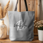 Glam Silver Brushed Metal Black White Monogram  Tote Bag<br><div class="desc">This elegant personalised tote bag features a monogram and first name in modern black and white script on a glam silver brushed metal background.</div>