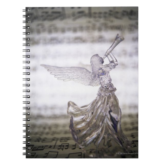Glass angel playing trumpet and image of sheet notebook (Front)