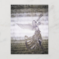 Glass angel playing trumpet and image of sheet