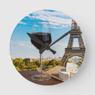Glass of wine with brie cheese on Eiffel tower Round Clock