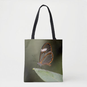 Glasswinged butterfly on a leaf tote bag