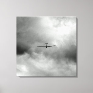 Glider flying in grey sky canvas print
