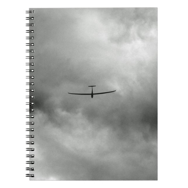 Glider flying in grey sky notebook (Front)