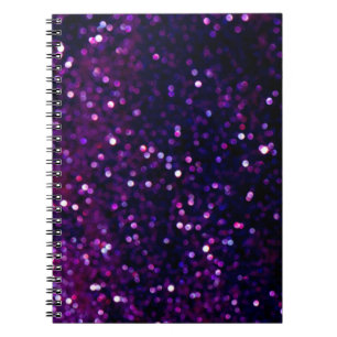 Glitter vintage lights background. purple and blac notebook