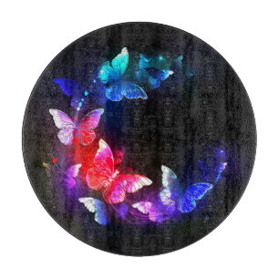Glowing Neon Night Butterflies on Black background Cutting Board