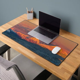 Glowing orange winter mountain range desk mat