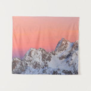 Glowing sunset sky and snowy mountains tapestry