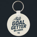 Goal Getter Distressed Player Name & Number Key Ring<br><div class="desc">For players who love that attacking mindset, this keychain turns “GOAL GETTER” into a bold everyday keepsake. The design shows a speeding soccer ball above the phrase, with “BRANDON” and “#10” as sample details that can be personalized for your athlete. That makes the product a strong fit for strikers, goal...</div>
