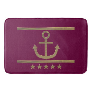 gold anchor on wine red background bath mat