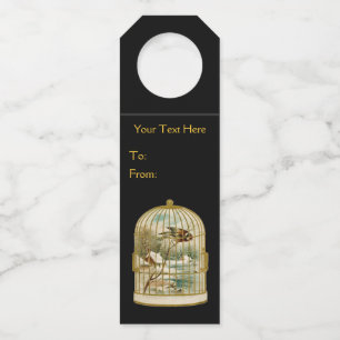 Gold Birdcage With Bird on Branch Winter Cabin Bottle Tag