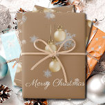 Gold Christmas Ornaments Wrapping Paper Sheets<br><div class="desc">Add festive sparkle to your packages with these Gold Christmas Ornaments Wrapping Paper Sheets. Featuring elegant Christmas ornaments with ribbon and bows and dangling hanging baubles, the design is accented by delicate white snowflakes for a cheerful holiday theme. The joyful greeting Merry Christmas appears in elegant script, while the simple...</div>