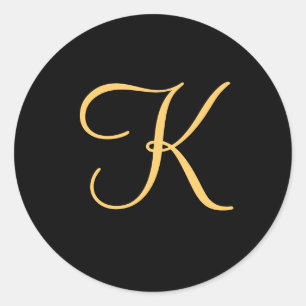 Gold-coloured initial K on black monogram sticker