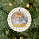 Gold First Christmas Pet Kitten Photo Paws Custom Ceramic Ornament<br><div class="desc">“My First Christmas.” Celebrate your new pet’s arrival this past year! A faux gold foil banner with your pet’s name and year in whimsical white typography overlays your kitten or puppy’s custom photo. A playful border of faux gold foil paw prints against white surrounds it. Feel the warmth and joy...</div>