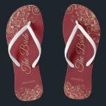 Gold Frills Crimson Red Elegant The Bride Wedding Thongs<br><div class="desc">Dance the night away with these beautiful wedding flip flops. Designed for the bride, they feature a simple yet elegant design with gold coloured script lettering on a crimson red background and fancy golden lace curls and swirls. Beautiful way to stay fancy and appropriate while giving your feet a break...</div>