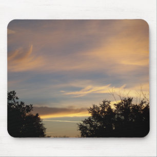 Gold hued clouds at dawn on a mouse pad