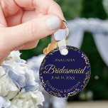 Gold Lace Bridesmaid Wedding Gift Navy Blue Key Ring<br><div class="desc">These keychains are designed to give as favors to bridesmaids in your wedding party. They feature a simple yet elegant design with a navy blue background,  gold lettering,  and a golden faux foil floral lace border. Perfect way to thank your bridesmaids for being a part of your special day!</div>