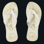 Gold Lace on Ivory Cream The Bride Elegant Wedding Thongs<br><div class="desc">Dance the night away with these beautiful wedding flip flops. Designed for the bride, they feature a simple yet elegant design with gold coloured script lettering on an ivory or cream coloured background and fancy golden lace curls and swirls. Beautiful way to stay fancy and appropriate while giving your feet...</div>